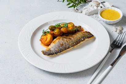 Mediterranean sea bass with potato, caper, olive, and tomato stew