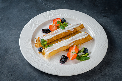 Homemade pancakes with curd, berries and caramel sauce
